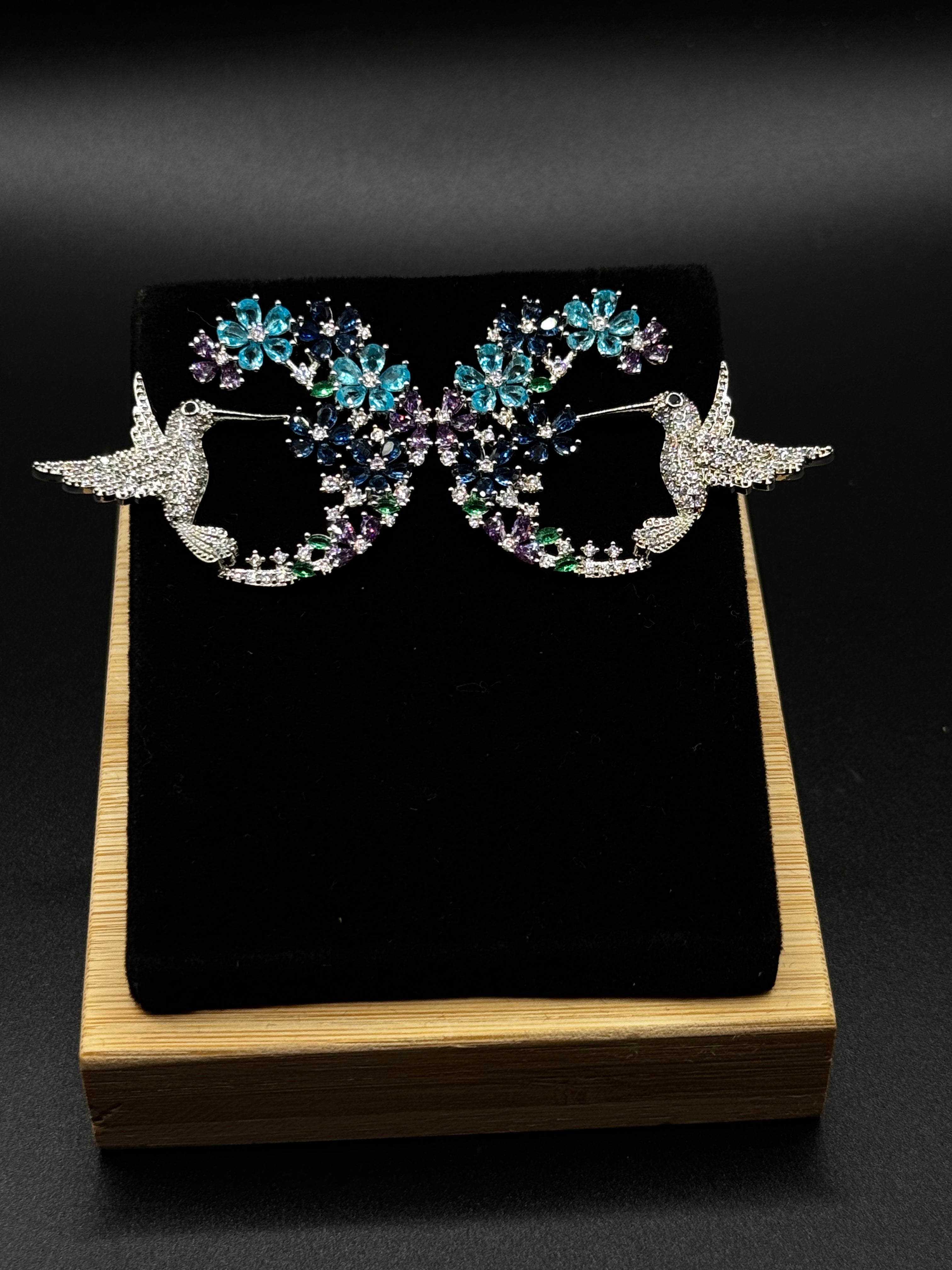 Hummingbird earring encrusted with crystal, aqua, and amethyst zirconia stones