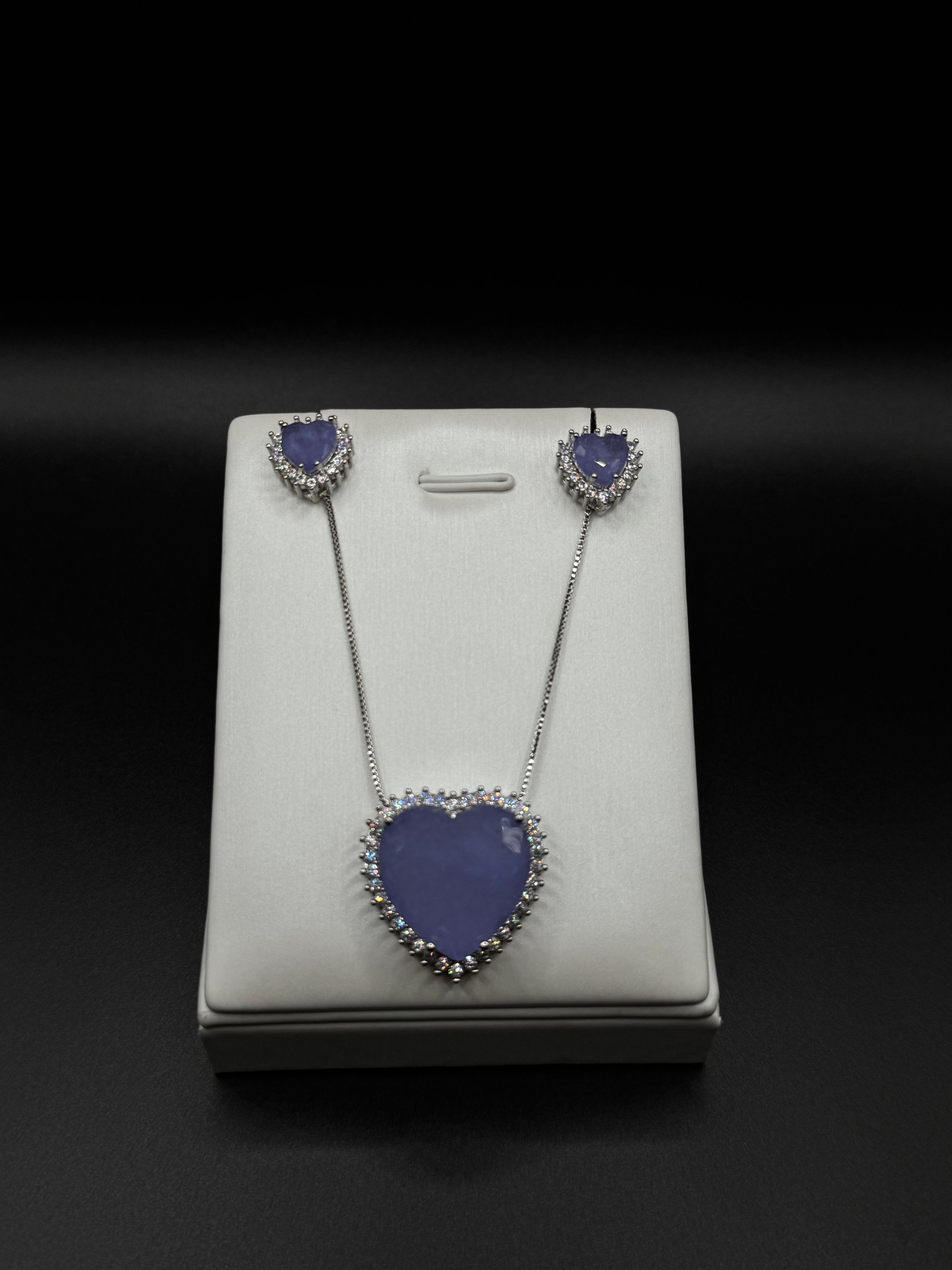 Heart-shaped set in rhodium plating with side-set details and amethyst fusion stone.