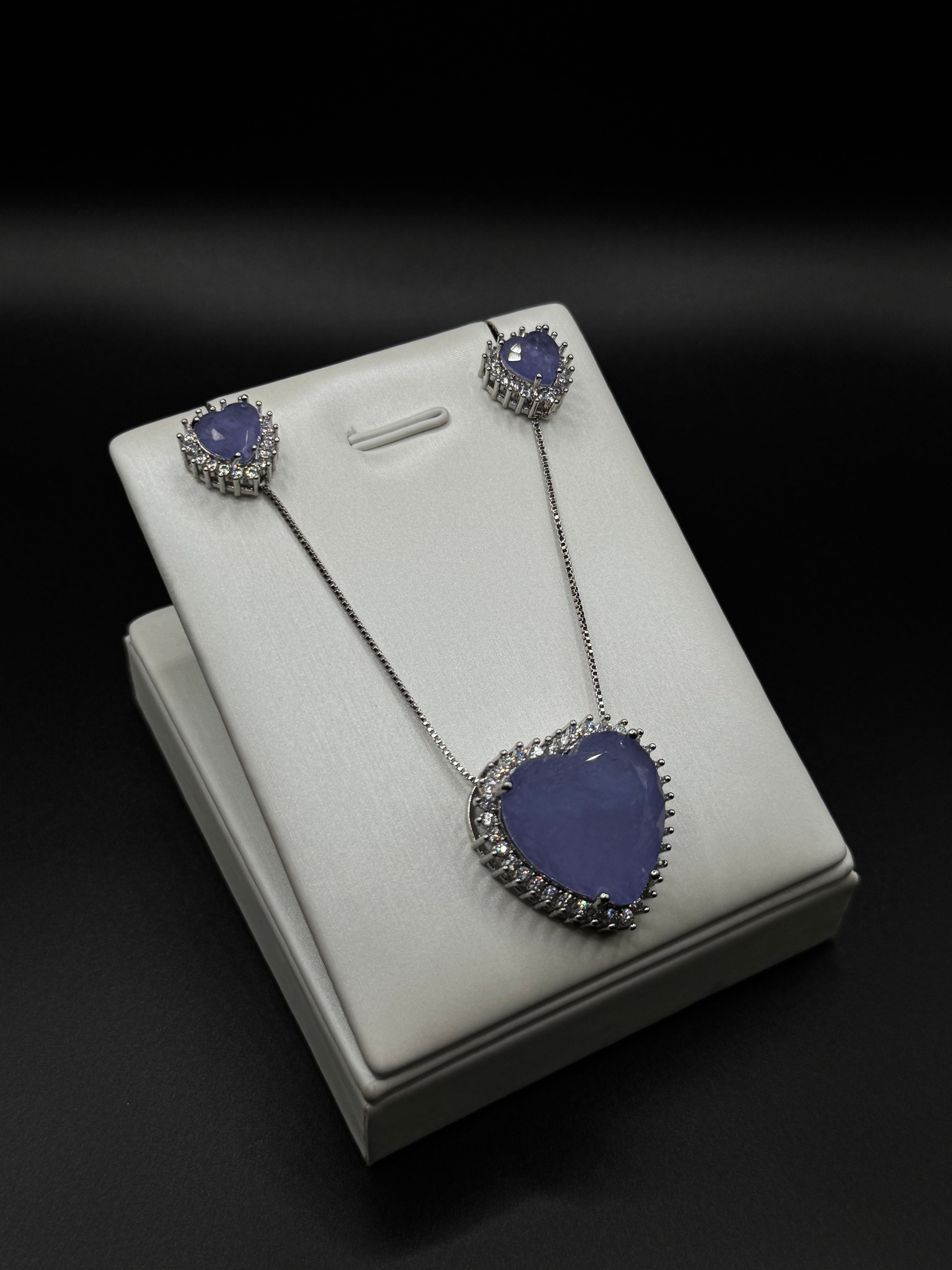 Heart-shaped set in rhodium plating with side-set details and amethyst fusion stone.