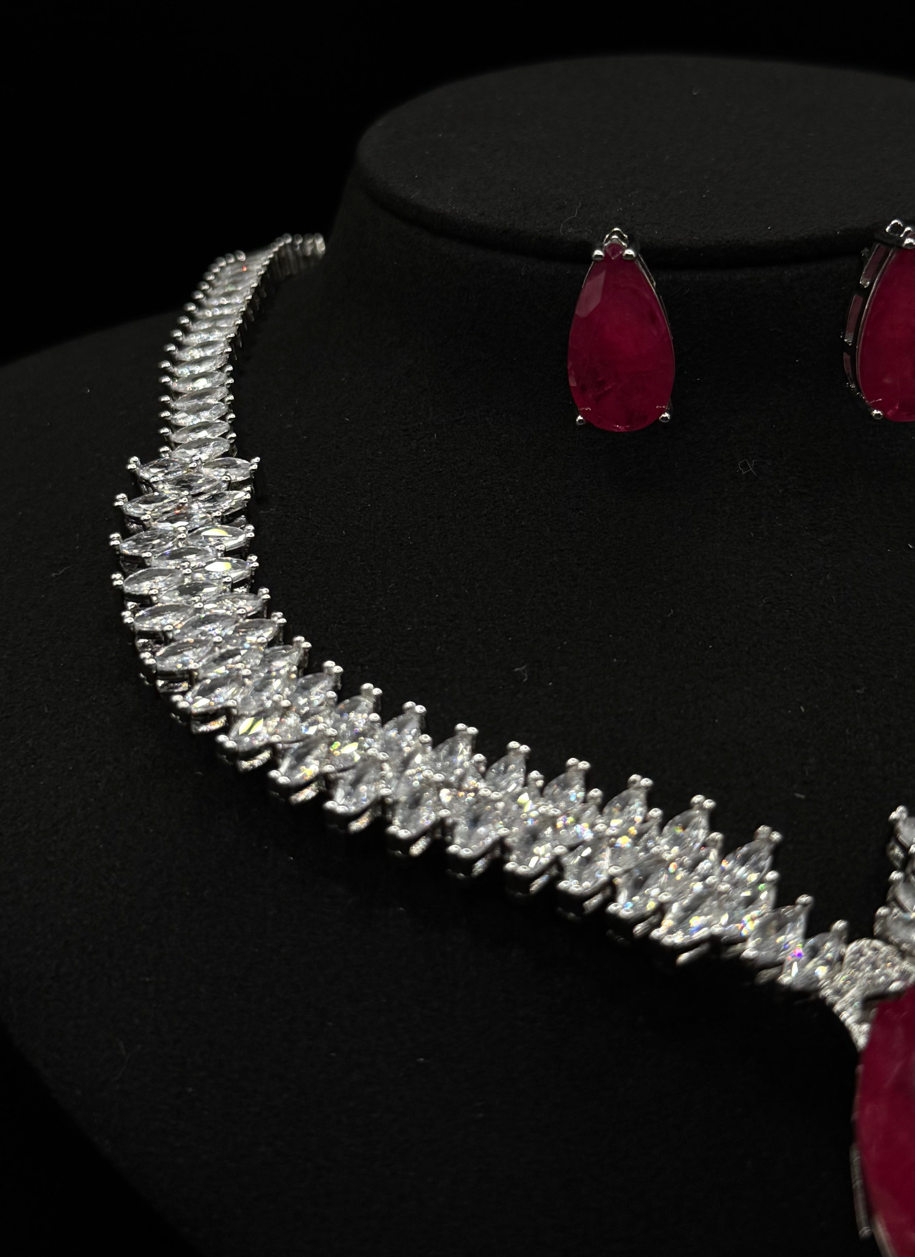 Luxury jewelry set fully encrusted with clear zirconia , featuring a ruby fusion stone pendant"