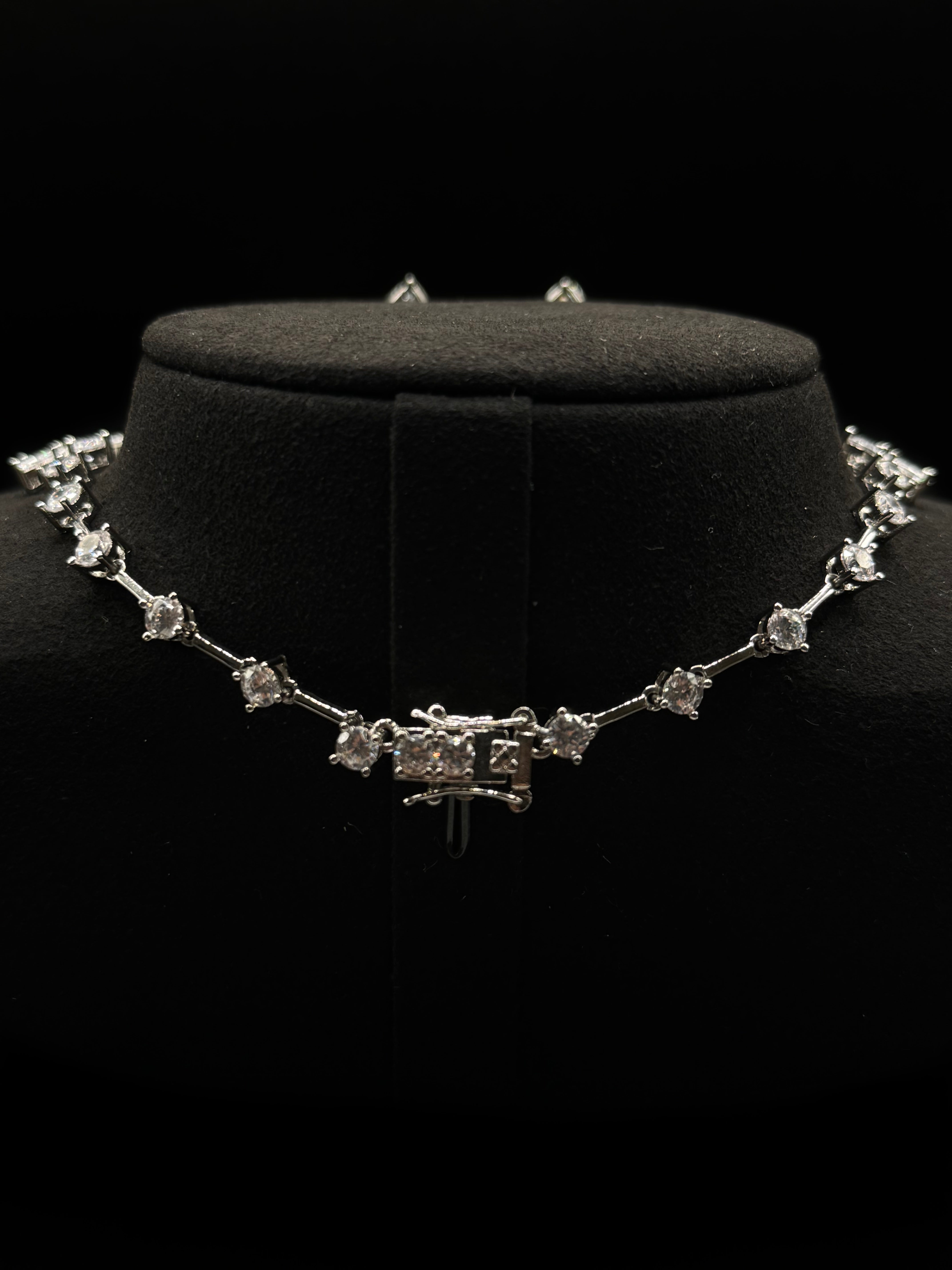Luxury rhodium-plated jewelry set with a teardrop-shaped turquoise fusion stone pendant