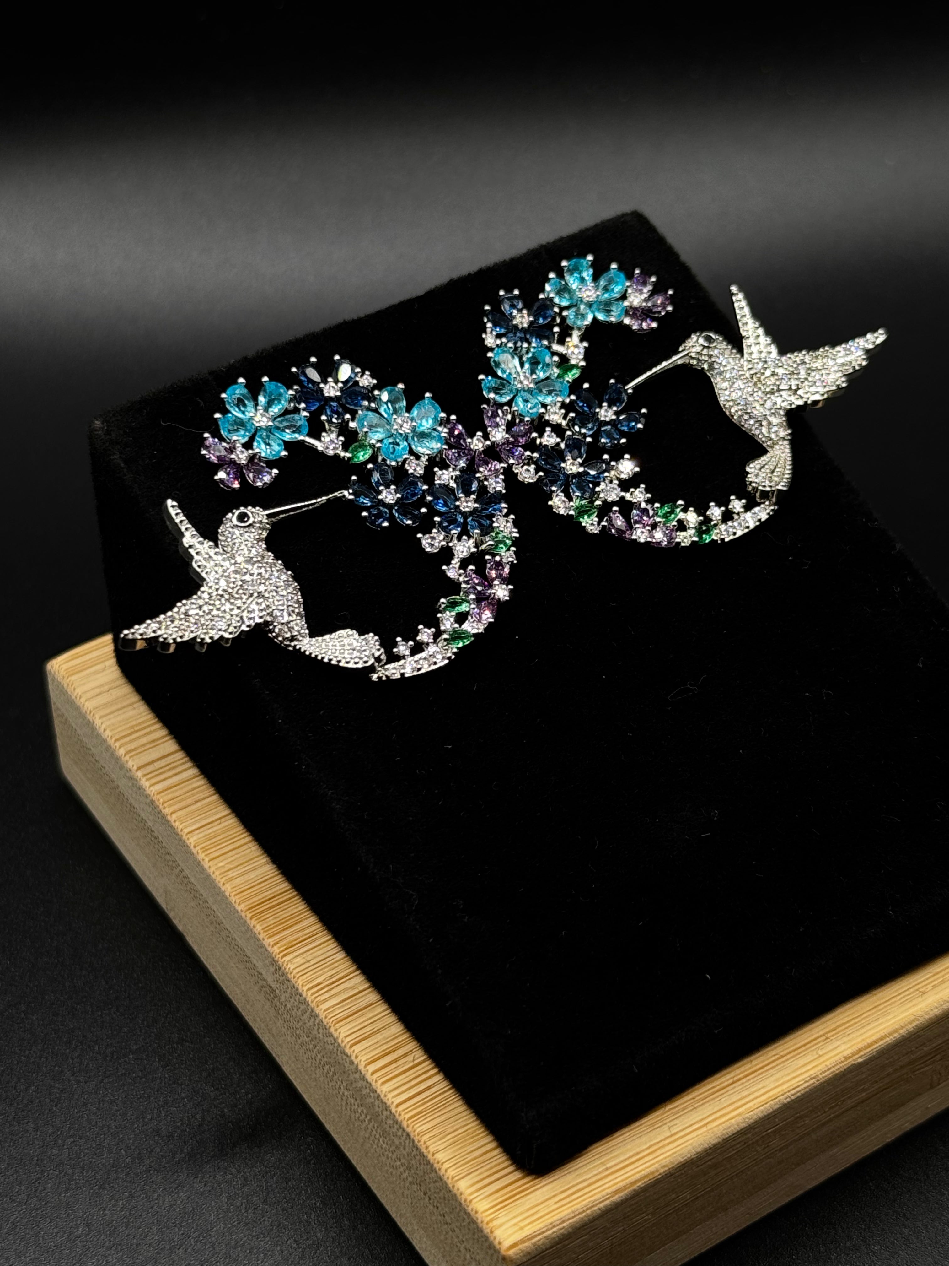 Hummingbird earring encrusted with crystal, aqua, and amethyst zirconia stones