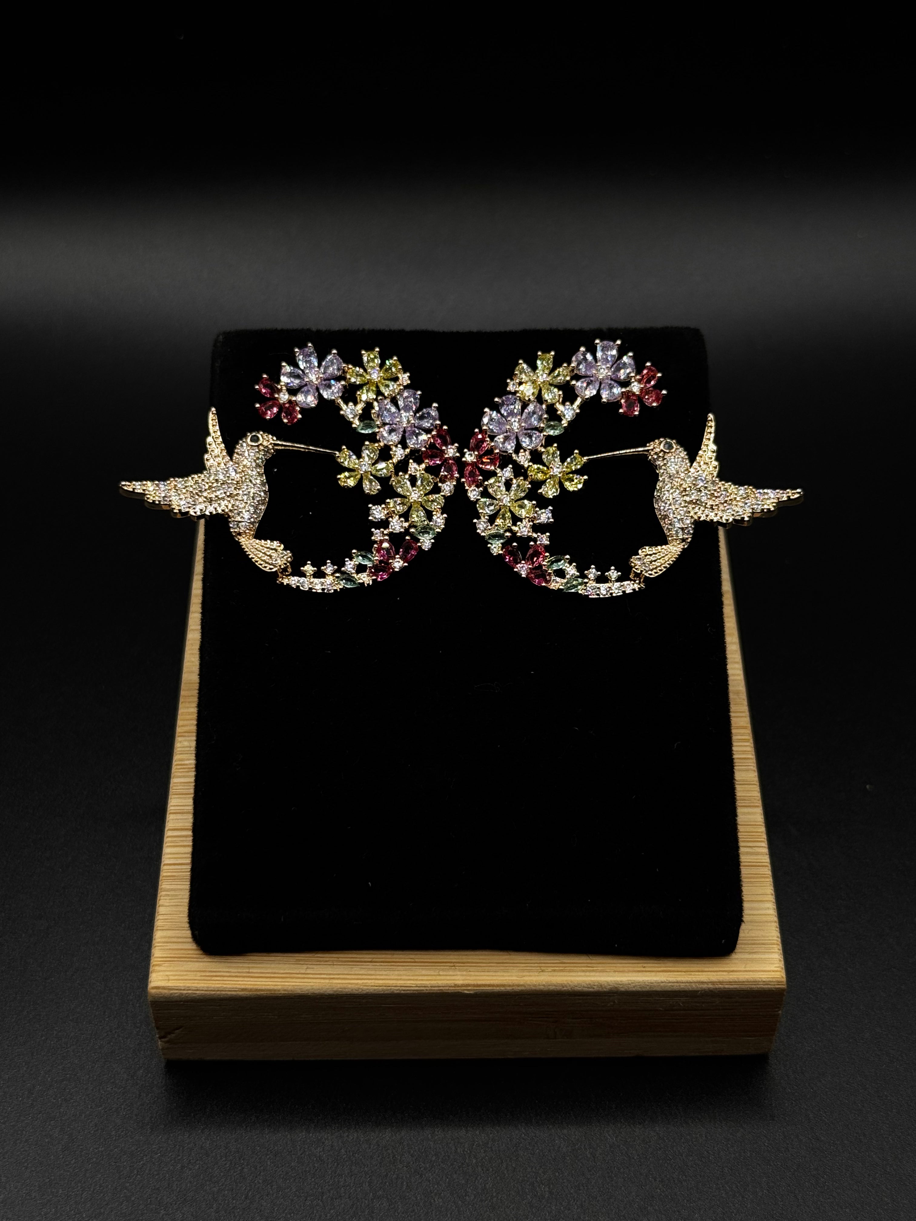 Hummingbird earring encrusted with crystal, aqua, and amethyst zirconia stones