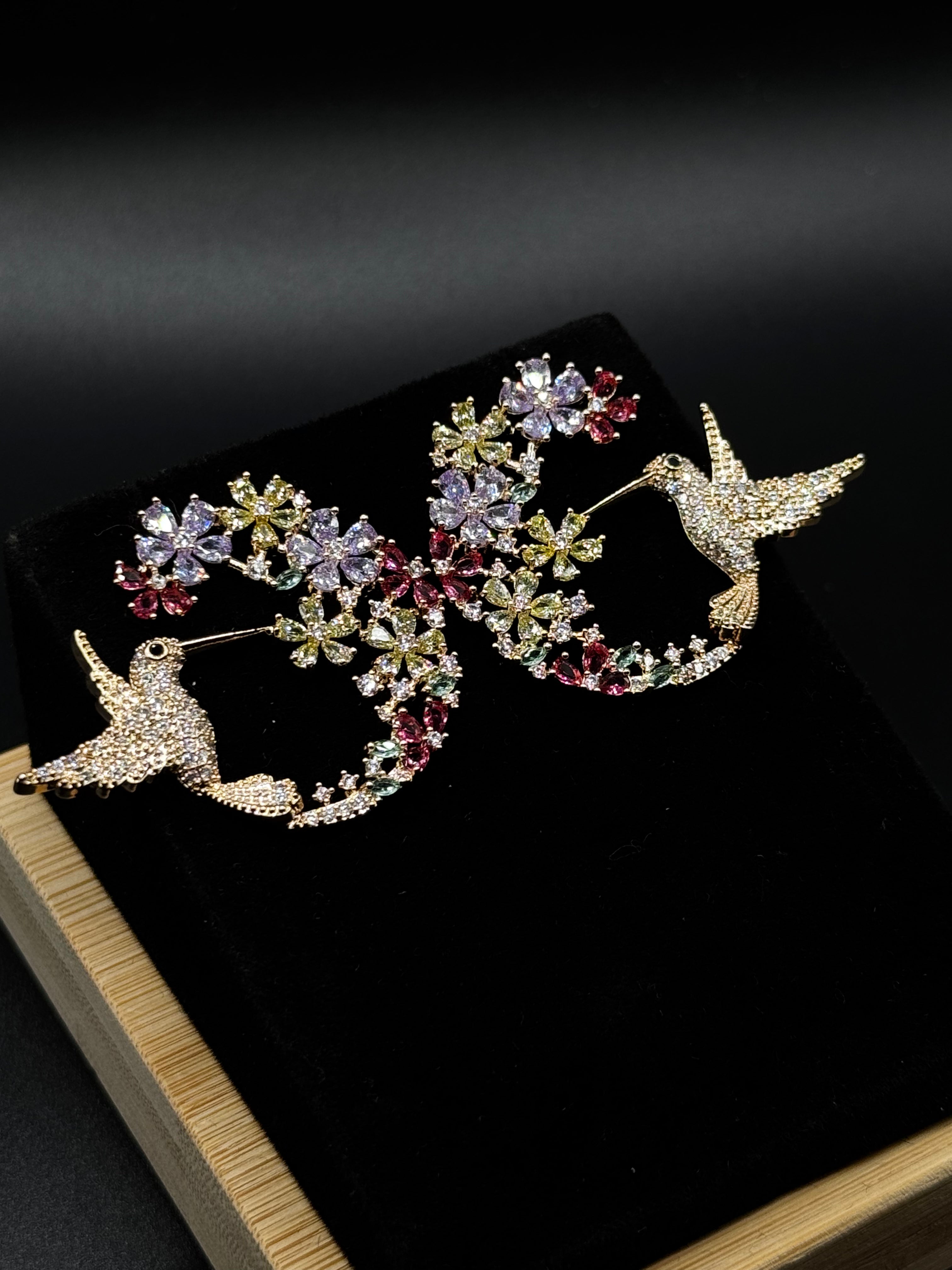 Hummingbird earring encrusted with crystal, aqua, and amethyst zirconia stones