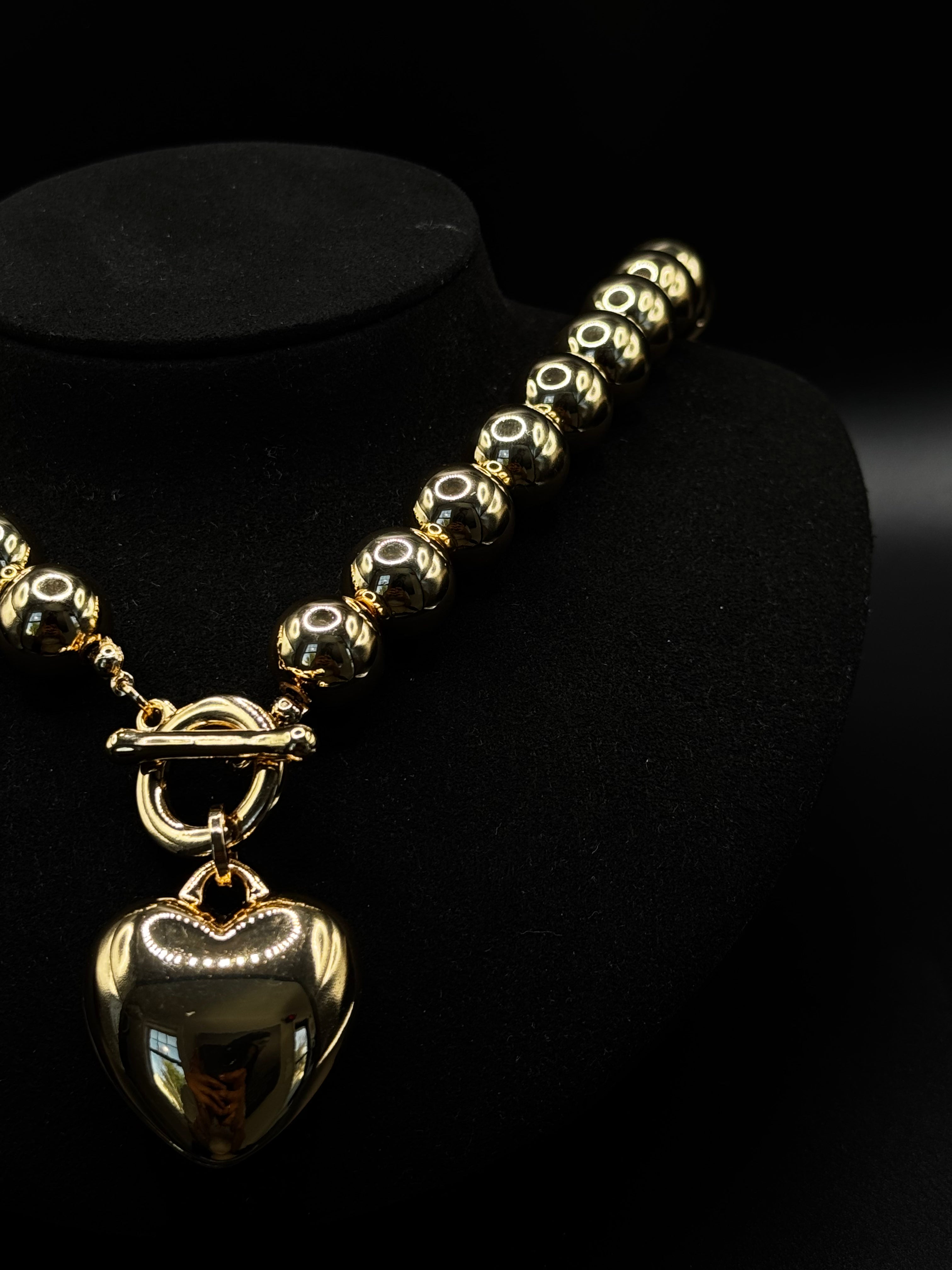 Rhodium-plated necklace featuring polished bead spheres