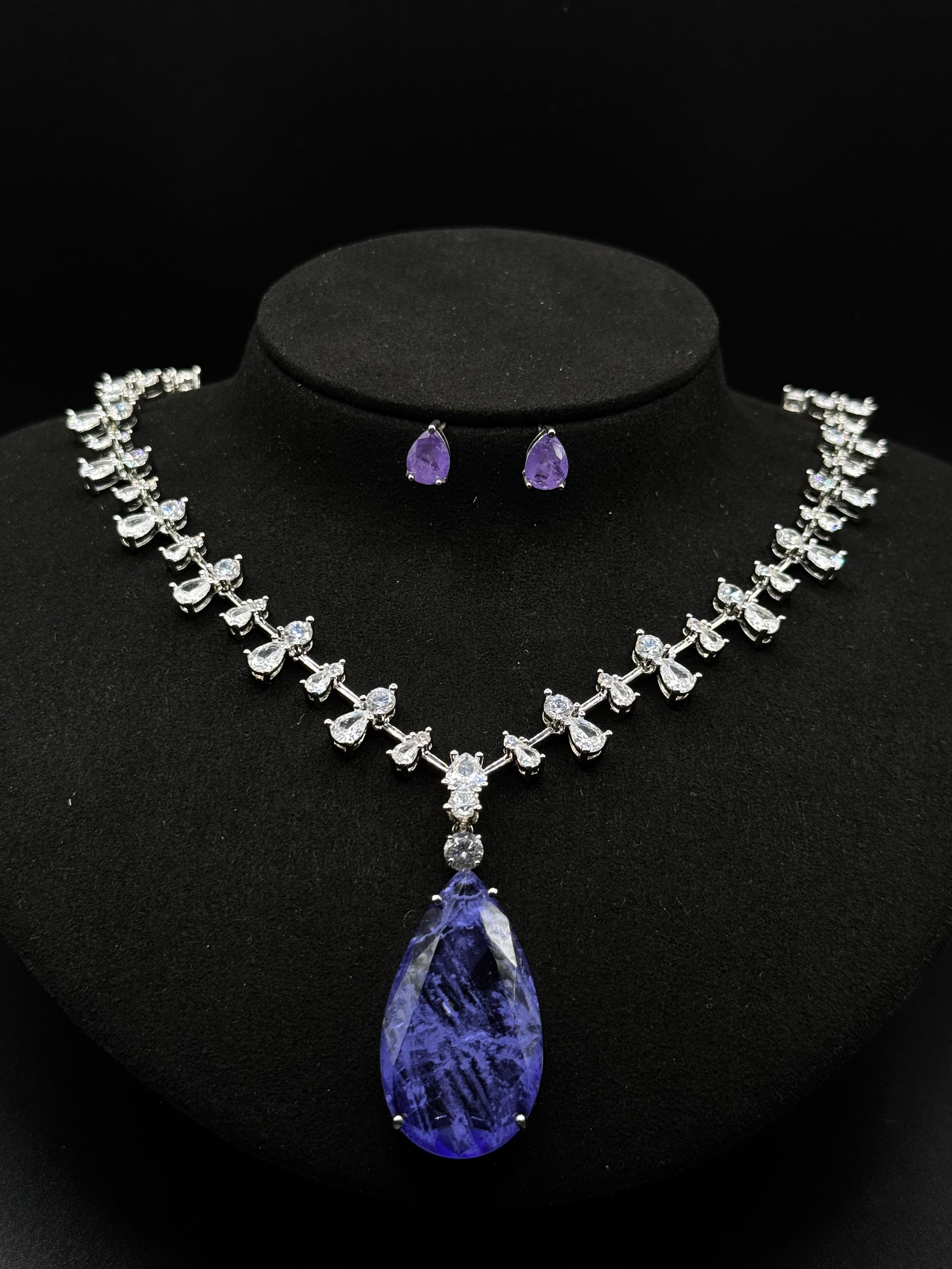 Luxury rhodium-plated jewelry set with a teardrop-shaped amethyst fusion stone pendant